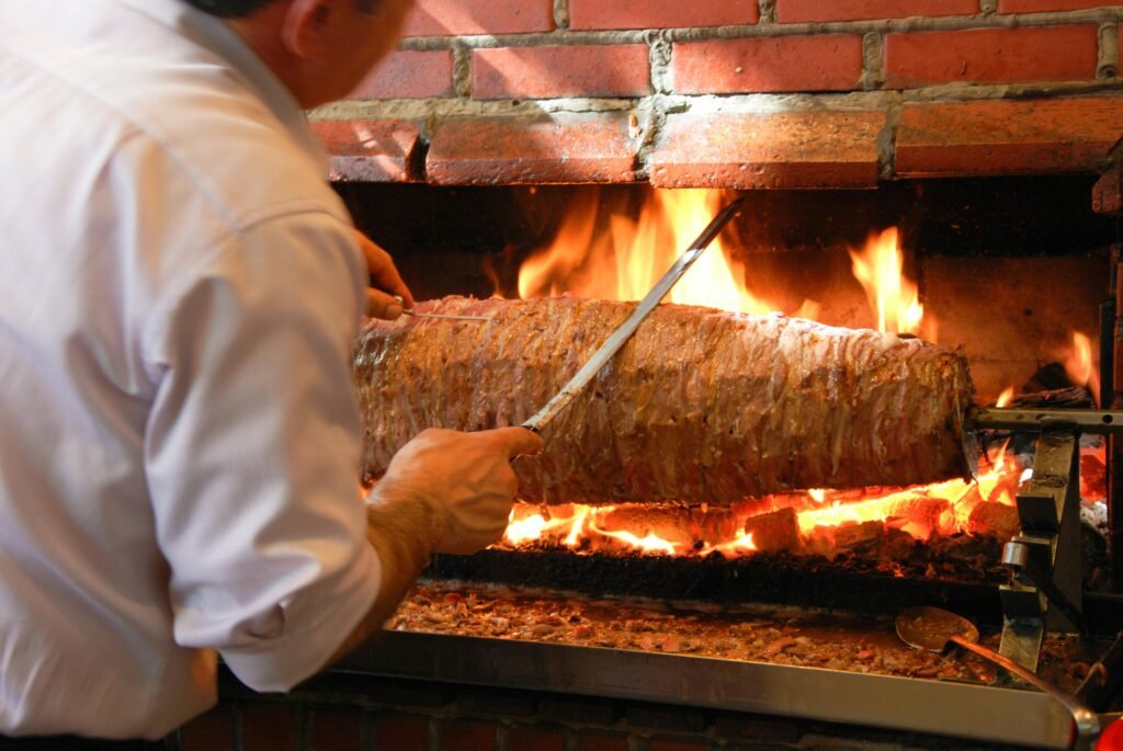 pexels-photo-8364505-8364505 A chef preparing traditional Turkish doner kebab in Istanbul using an open flame grill.